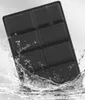 A black cushion is shown being splashed with water. Produktbild-Vorschau