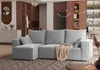 A modern living room with a gray sectional sofa, a throw blanket, and decorative elements. Produktbild-Vorschau