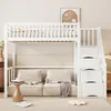 A white loft bed with stairs and storage drawers, set up in a room with beige sofas and a small wooden table. Voir les images du produit