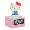 A pink Hello Kitty digital alarm clock with a Hello Kitty figurine on top. Podgląd zdjęcia produktu