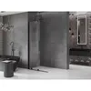 A modern bathroom with a black bathtub, a shower enclosure, and a vanity with a mirror. Podgląd zdjęcia produktu