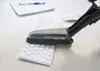 A vacuum cleaner brush attachment is cleaning a white keyboard on a desk. Produktbild-Vorschau