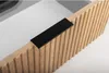 A close-up view of a wooden cabinet with a black handle. Anteprima dell’immagine prodotto