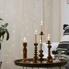 Candles on a tray in front of a curtain with fairy lights. Produktbild-Vorschau