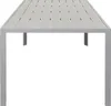 A light gray aluminum dining table with a slatted top and simple frame, shown from a front-facing, slightly elevated angle against a white background. Produktbild-Vorschau