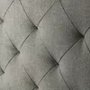 A close-up view of a tufted fabric surface with diamond-shaped stitching. Produktbild-Vorschau