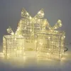 Three illuminated gift boxes with bows, arranged on a surface. Produktbild-Vorschau