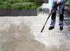 A person is pressure washing a patio with a PARKSIDE® Hochdruckreiniger »PHD 170 D2". Produktbild-Vorschau