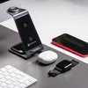 A desk setup with a wireless charging station, smartphone, wireless earbuds, and a keyboard. Produktbild-Vorschau