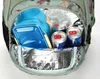 The inside of a backpack with a lunchbox and two cans of energy drink. Produktbild-Vorschau