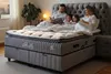 A family reading a book in bed. Produktbild-Vorschau