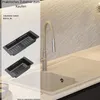 A kitchen sink area with a faucet and two adjustable baskets displayed on the left side. Produktbild-Vorschau
