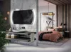 A modern bathroom vanity with a large illuminated mirror is adjacent to a bedroom with a pink duvet. Produktbild-Vorschau