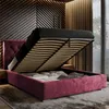A bedroom scene with a bed frame open, revealing storage space underneath. The bed has a tufted headboard and is covered in a dark fabric. The background features wooden wall paneling and blinds on a window. Produktbild-Vorschau