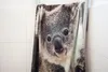 A towel with a koala print hanging on a rack against a tiled wall. Podgląd zdjęcia produktu