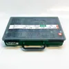 A green and gray plastic case containing various screws, with a transparent lid showing the compartments. Podgląd zdjęcia produktu