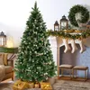 A decorated Christmas tree with presents underneath, next to a fireplace with stockings hung. Anteprima dell’immagine prodotto
