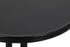 A close-up view of the edge of a round, black table. Produktbild-Vorschau