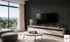 A modern living room with a large window overlooking a scenic landscape, featuring a TV, entertainment unit, coffee table, and ottoman. Náhled obrázku produktu