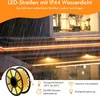 LED strips installed on outdoor stairs during rain, with a spool of LED strips in the foreground. Produktbild-Vorschau