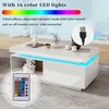 A white, high-gloss coffee table with LED lighting is shown in a modern living room setting. Voir les images du produit