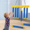 A young child is playing with a hanging toy that appears to be a set of colorful tubes. Náhled obrázku produktu