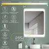A bathroom mirror with integrated lighting and digital clock, showcasing its features. Produktbild-Vorschau