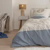 A bedroom scene with a bed, nightstand, and chair. Produktbild-Vorschau
