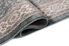 A close-up view of a rolled-up rug with a classic pattern. Voir les images du produit