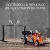 A LEGO Technic race truck is shown on a wooden surface in front of a gray wall. A black stand with two white arms is positioned behind the truck. Anteprima dell’immagine prodotto