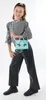 A young girl poses with a purse. Náhľad obrázku produktu