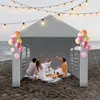 People having a picnic under a party tent on a beach. Produktbild-Vorschau