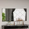 A rectangular mirror with a geometric pattern is displayed above a console table with decorative items. Produktbild-Vorschau