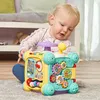 A baby is playing with a colorful VTech activity cube on the floor. Náhled obrázku produktu