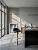 Eleganter Barhocker in Schwarz mit Edelstahlgestell an einer massiven Granit-Kücheninsel in einem puristischen und modernen Loft._#sku_SAFWL1.281# Produktbild-Vorschau