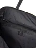 The inside of a black tote bag with a repeating "GUESS" logo pattern on the lining. Produktbild-Vorschau