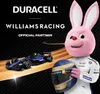 A pink bunny mascot in a racing suit holds a helmet next to a Formula 1 car, with Duracell and Williams Racing branding. Anteprima dell’immagine prodotto