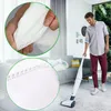 A man is vacuuming a living room with a cordless vacuum cleaner. There are close-up insets showing the material of vacuum bags. Produktbild-Vorschau