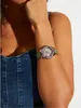A woman's arm wearing a multicolor Guess watch. Náhľad obrázku produktu