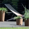 Outdoor patio scene with planters and a lounge chair. Náhled obrázku produktu