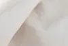 A close-up view of white or off-white fabric, likely linen or cotton, showing its texture and weave. Produktbild-Vorschau