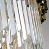A close-up view of a crystal chandelier with gold accents. Produktbild-Vorschau