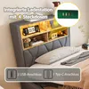 A bed with a headboard featuring integrated storage and lighting, along with a charging station. Náhľad obrázku produktu