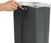A hand is shown placing a plastic bag into a gray trash can. Anteprima dell’immagine prodotto
