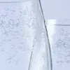 A close-up view of a clear glass with an embossed floral pattern. Podgląd zdjęcia produktu