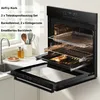 An open built-in oven with accessories displayed on a kitchen counter next to a sink. Voir les images du produit