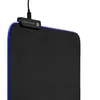 A close-up view of a black mousepad with blue LED lighting around the edge. Produktbild-Vorschau