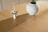 A close-up shot of a wooden table with a candle holder and a vase. Voir les images du produit