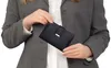 A person holding a wallet. Produktbild-Vorschau
