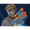 A young person wearing safety glasses holds a toy gun. Podgląd zdjęcia produktu